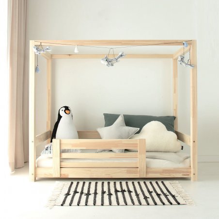 Frontansicht des TUULA MODERN Bettes mit Gittern, Teppich, Kuscheltieren und Kissen Frontansicht des TUULA MODERN Bettes mit Gittern, Teppich, Kuscheltieren und Kissen
