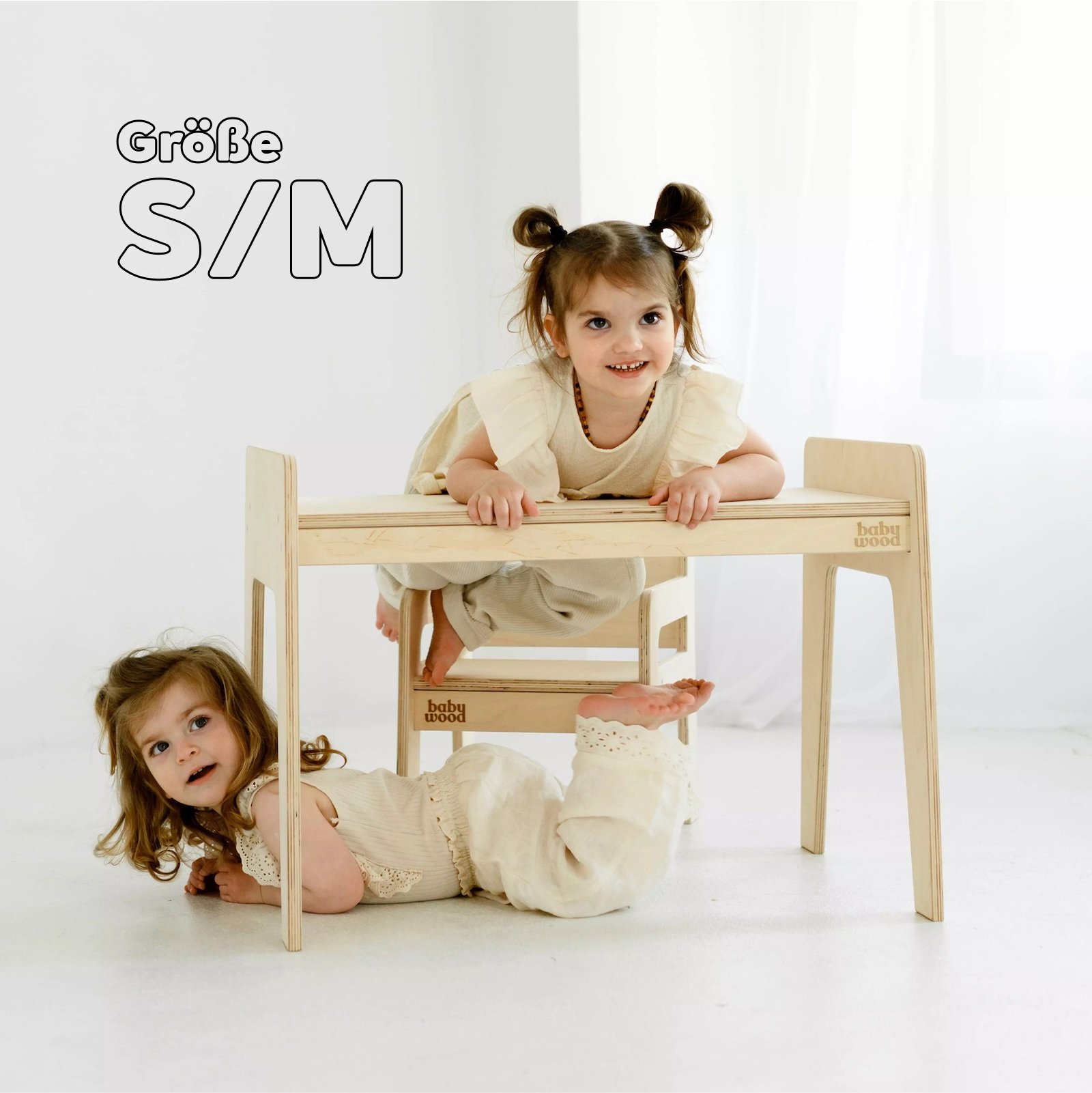 Kindertisch und Stuhl aus Holz, zwei Mädchen spielen zusammen