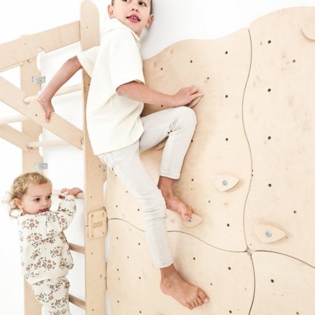 unge an der Kletterwand, daneben Mädchen auf der Sprossenleiter - Spaß im Kinderzimmer